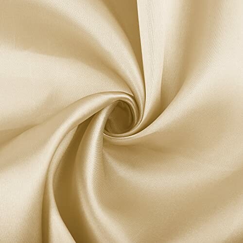 Close-up of beige satin fabric with a swirl pattern.