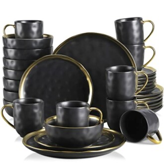 Elegant black and gold dinnerware set with cups and plates