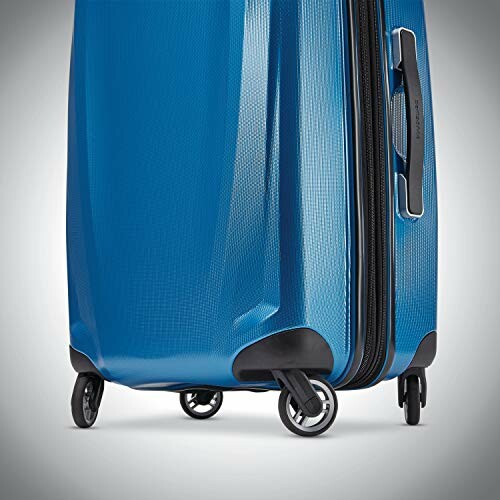 Close-up of blue hard-shell suitcase with wheels