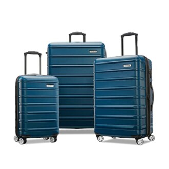 Three blue hard-shell suitcases of varying sizes with wheels and handles.