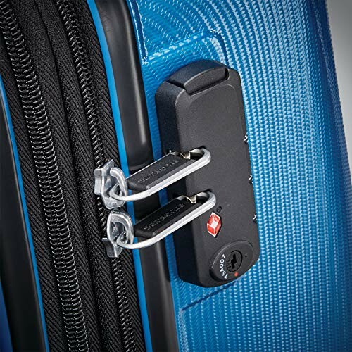 Close-up of a blue suitcase with TSA lock and zippers.