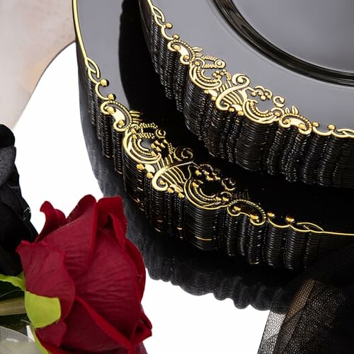 Elegant black plate with gold detailing and a red rose