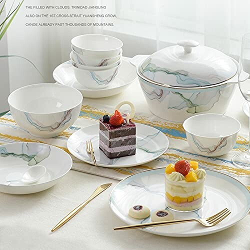 Elegant dinnerware set with marble design and desserts on a table