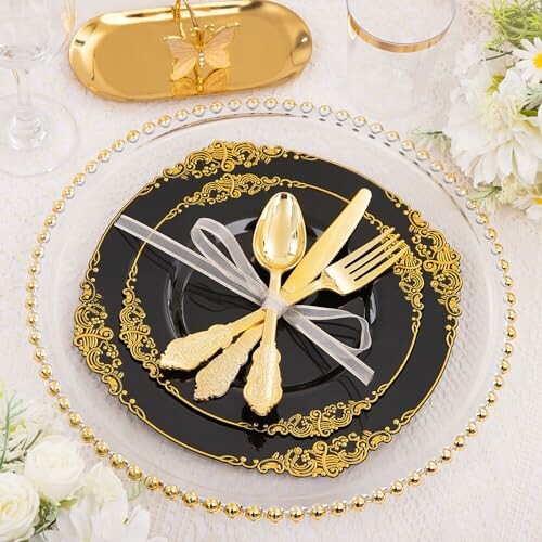 Elegant gold and black dinnerware set with decorative utensils.