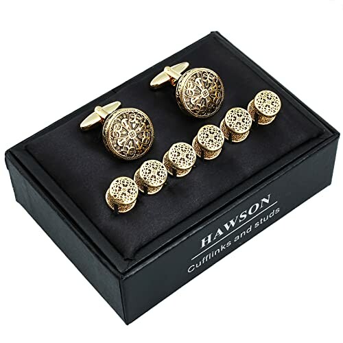 Gold cufflinks and studs set in black box.