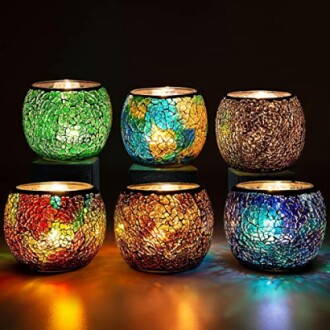 Colorful mosaic tealight candle holders arranged in two rows.