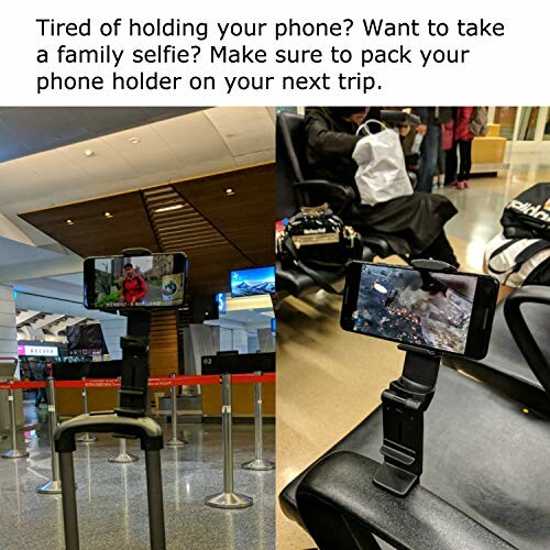 Phone holder attached to luggage in airport for hands-free use.