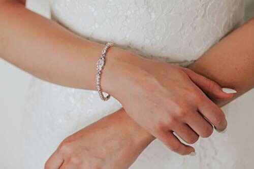 Woman in white dress wearing an elegant bracelet.