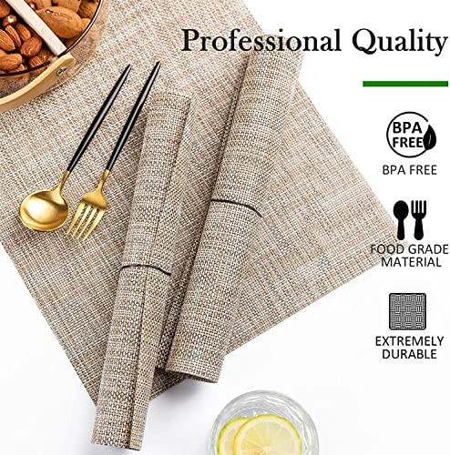 Woven table mats with black chopsticks, gold spoon and fork, and a lemon water glass.